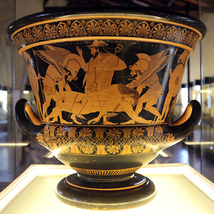 The ornate exterior of a black- and gold-painted ancient Greek vessel - a photo of the Euphronios Krater. The ornate exterior of a black- and gold-painted ancient Greek vessel - a photo of the Euphronios Krater.