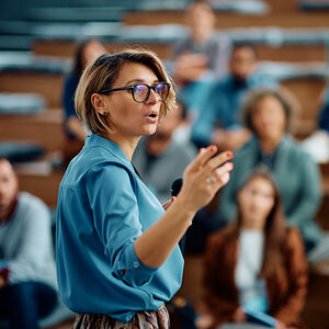A woman leading a conference. A woman leading a conference.